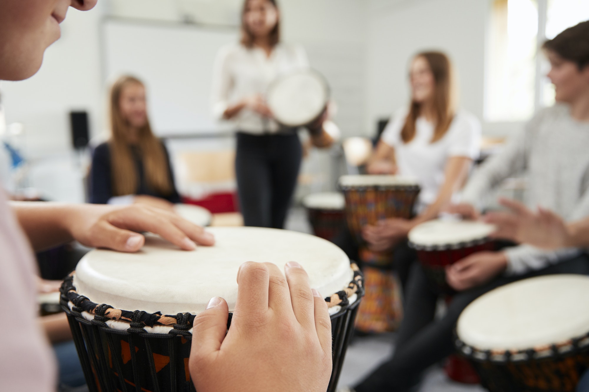 teenage students studying percussion in music class